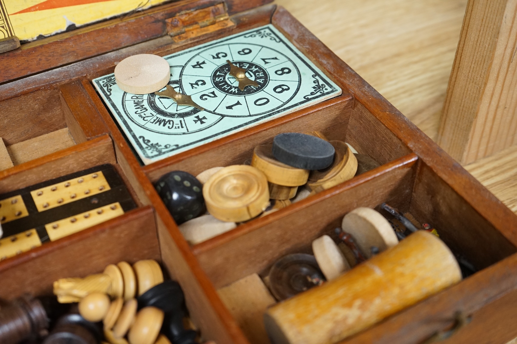A wooden boxed games compendium, 33cm wide x 19.5cm deep